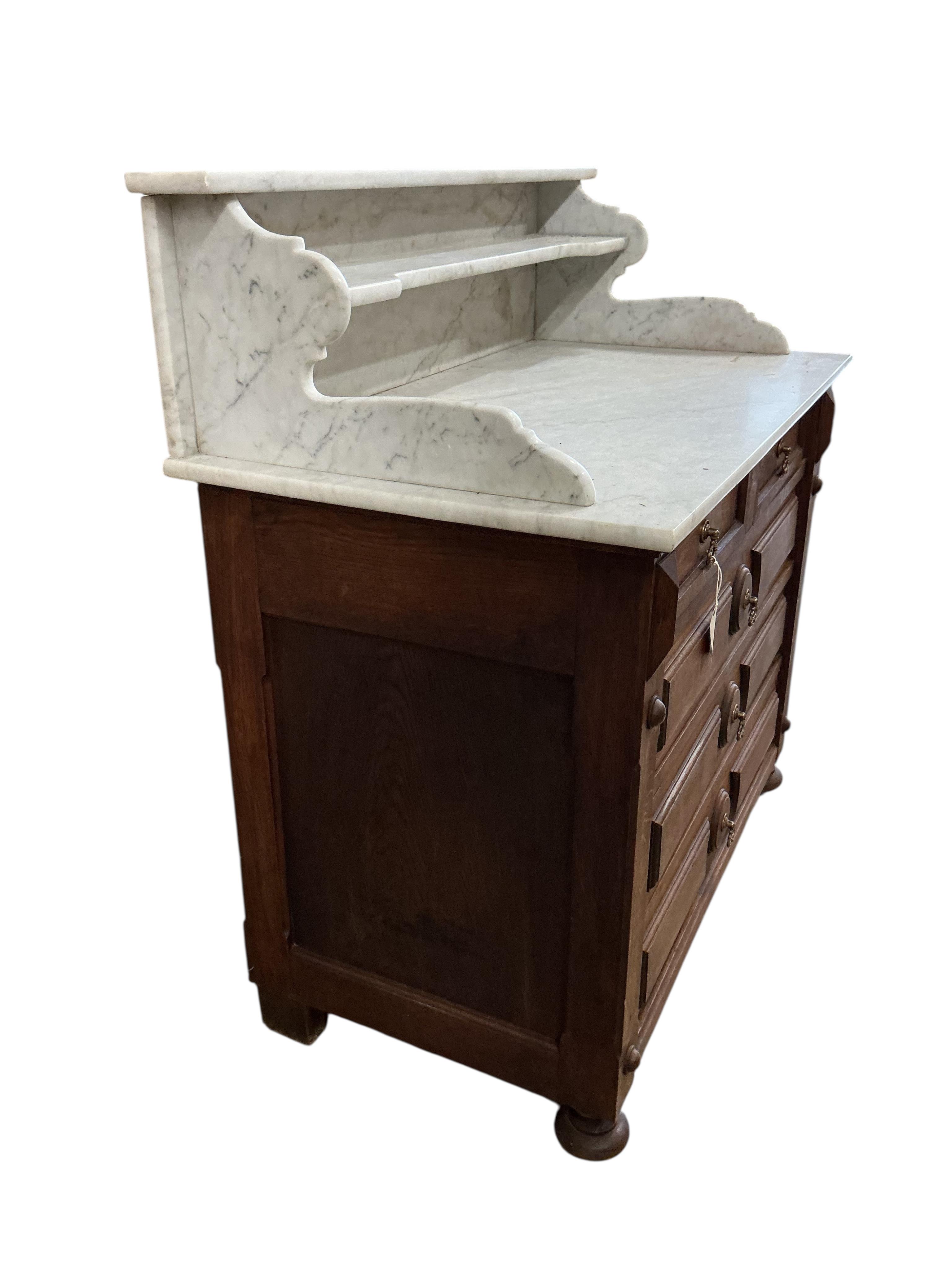 A late 19th century French oak marble top washstand, width 106cm, depth 58cm, height 112cm